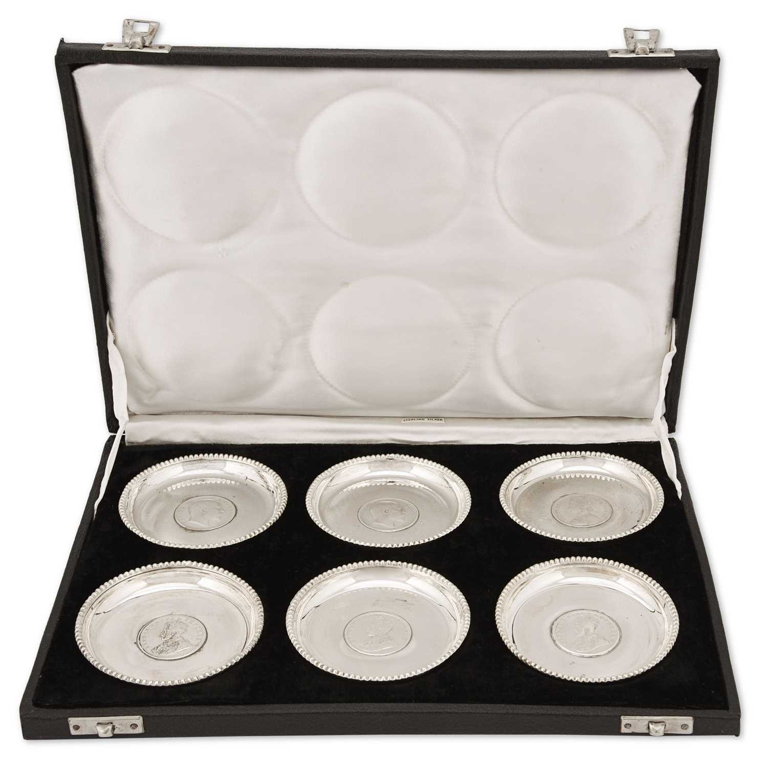 Lot 8 - A boxed set of six Indian silver plates.