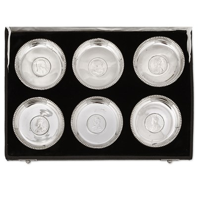 Lot 8 - A boxed set of six Indian silver plates.
