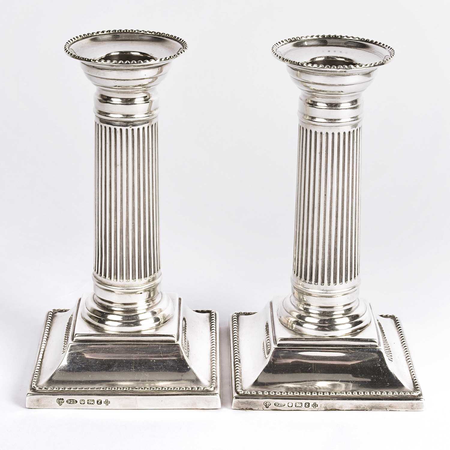 Lot 57 - British silver column candle holders.