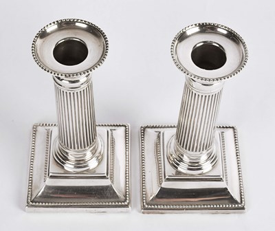 Lot 57 - British silver column candle holders.