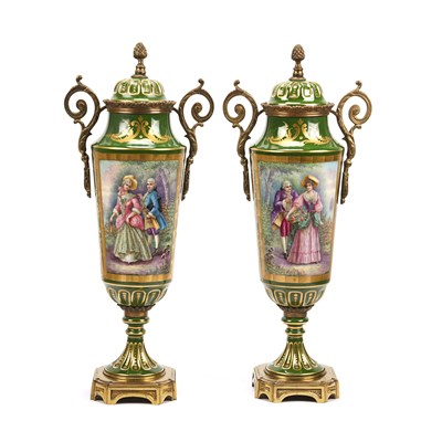 Pair of 19th-20th century green Limoges porcelain urns with gilt decoration and hand-painted scenes
