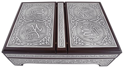 A silver Quran box with Quran