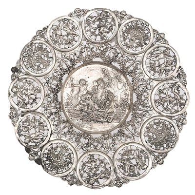 A circular silver European centerpiece
