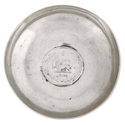Circular silver dish with Iranian 10 riyal silver coin