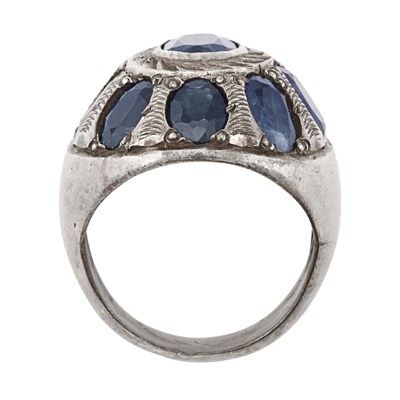 An antique dome shaped silver sapphire ring encircled with eight cushion cut sapphire stones.